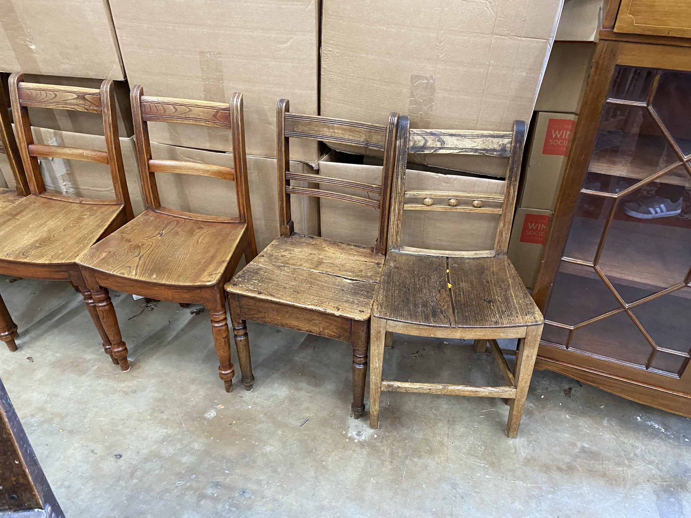 A harlequin set of nine early 19th century Provincial elm and fruitwood dining chairs